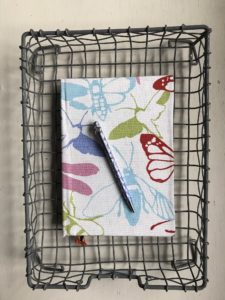 pretty linen fabric covered notebook in wire tray with pen - flatlay