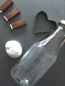 stamps, clay, glass bottle and heart cutter used for clay christmas decorations