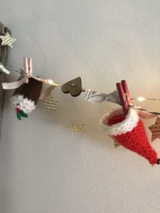 knitted mini christmas decorations with button heart and paper stars