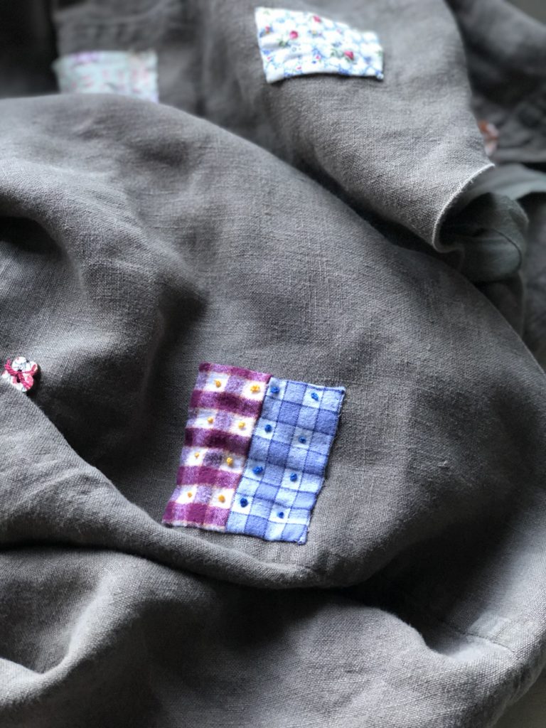 vintage fabrics and buttons on linen apron