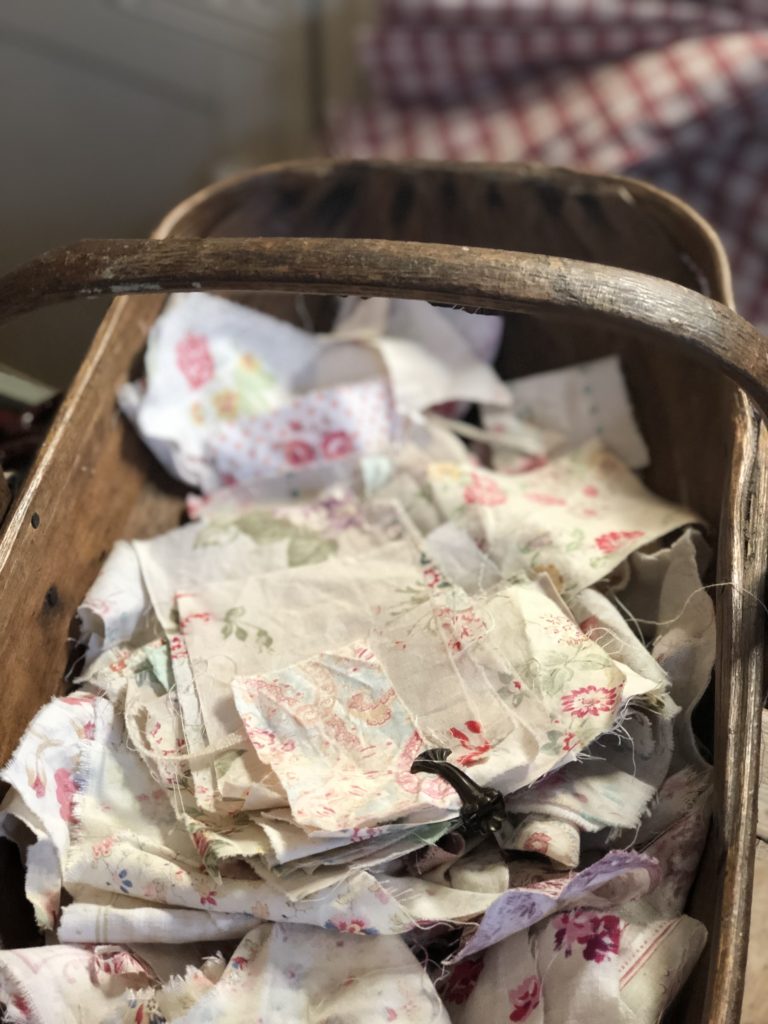 vintage french fabric scraps on wooden trug