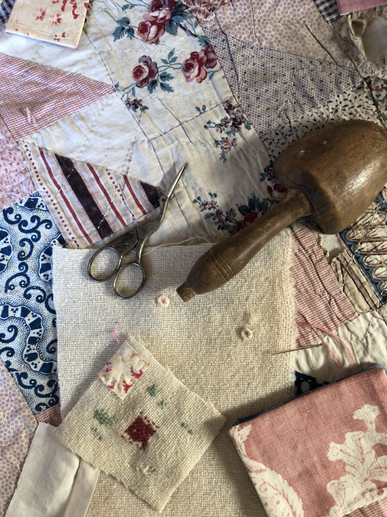 how to darn a hole using darning mushroom, scissors and fabric scraps