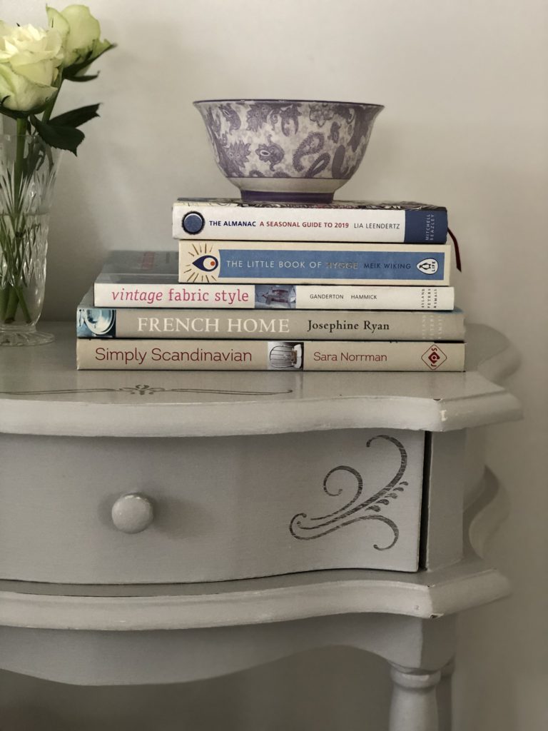 stencilled bedside table - finished with books roses and bowl rhs