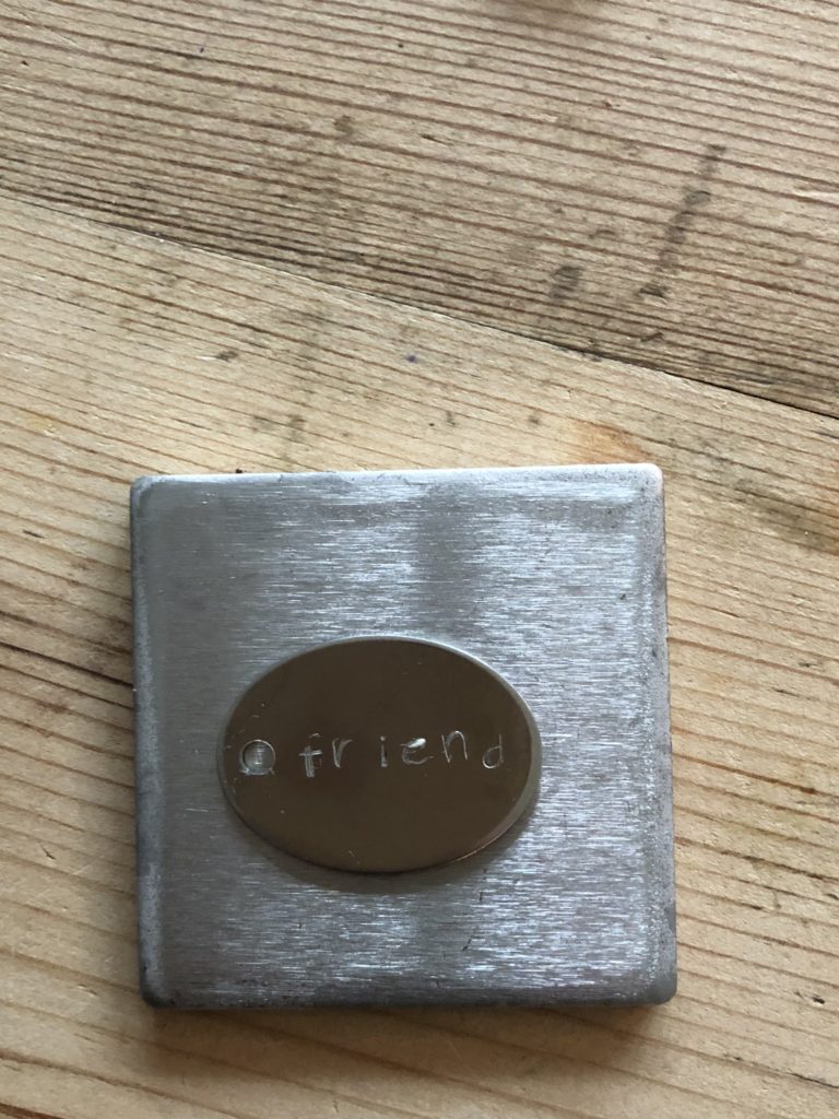 Metal Stamping - friend tag on metal stamping block