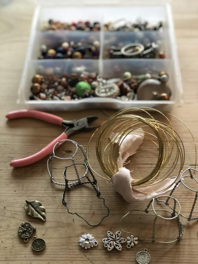 Wires and trinkets and pliers used to make decoration