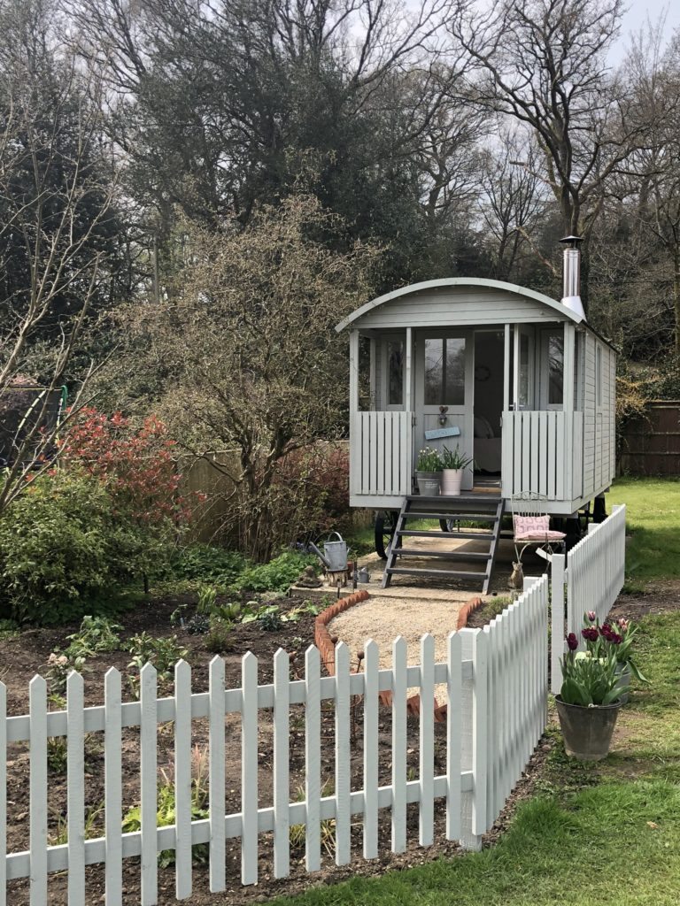 Shepherd's Hut and newly planted Cottage Garden with picket fence