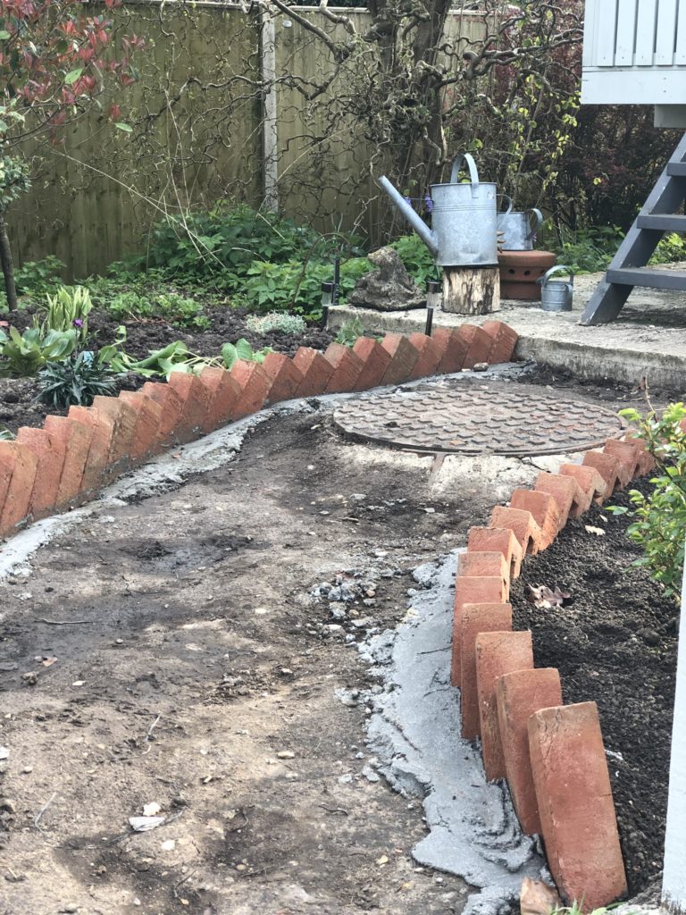 edging a cottage garden path with bricks