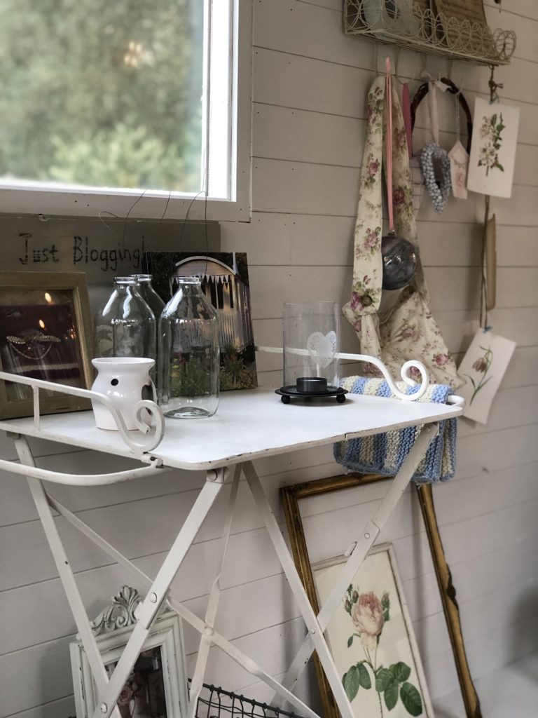 white iron desk with selection of vintage decor