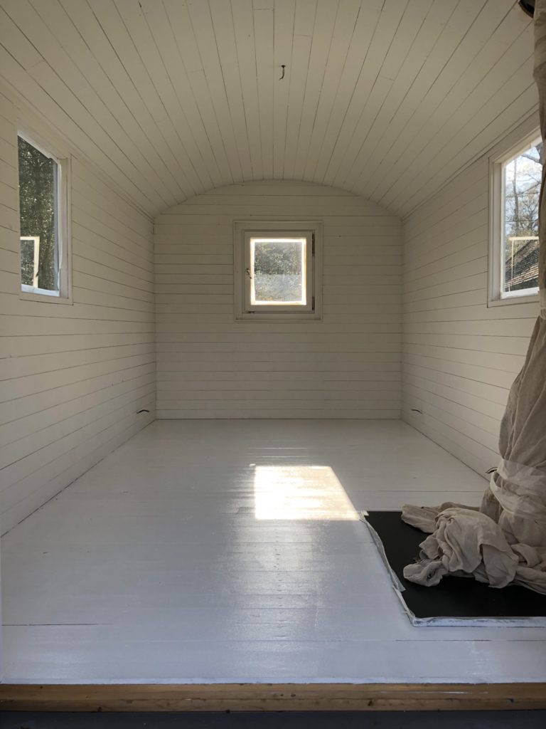 painting the interior of a shepherd's hut white