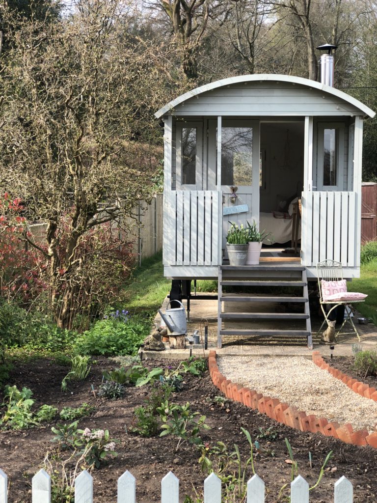 The Cottage Garden, shepherd's hut and gravel path