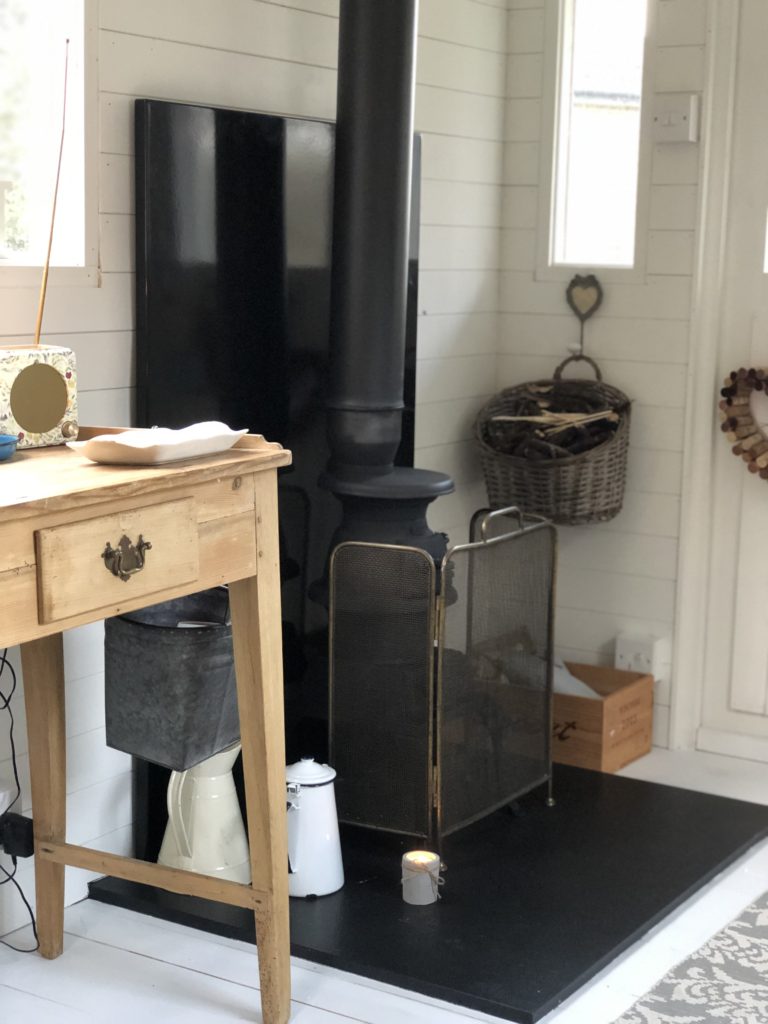 pine desk and wood burning stove with fireguard