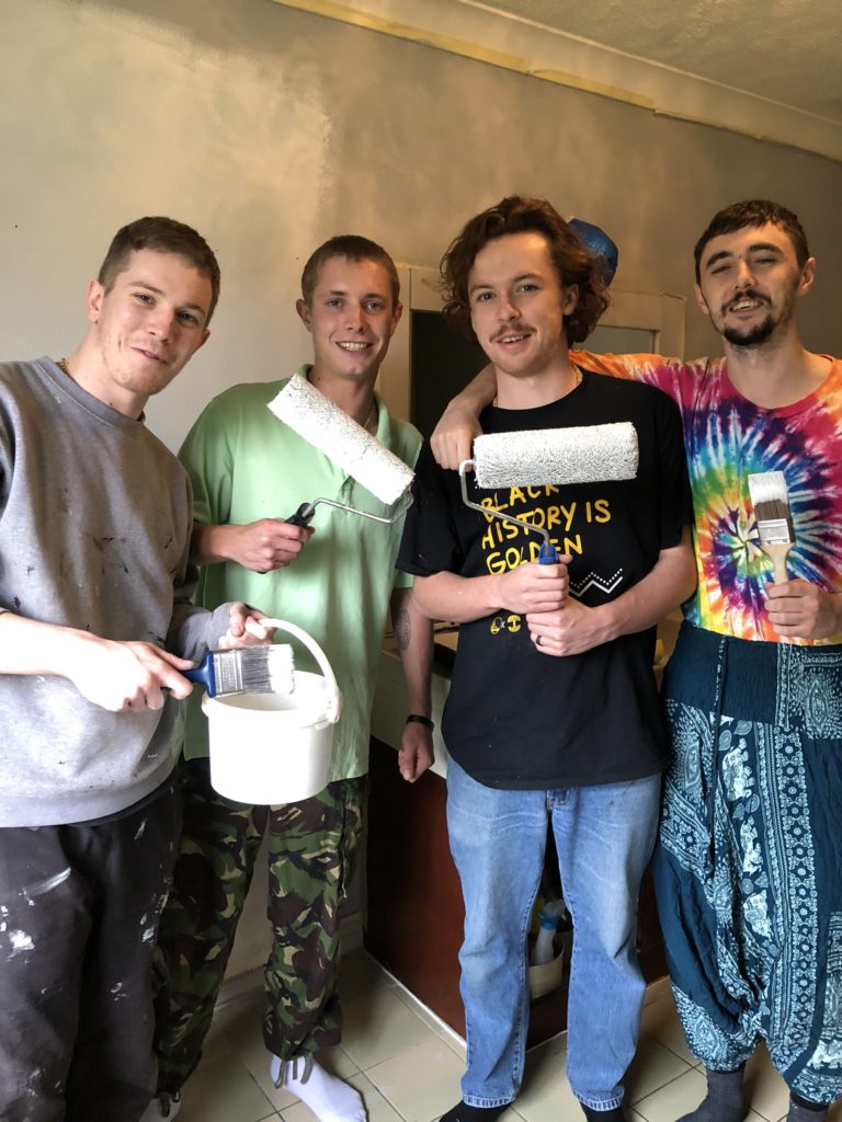 four lads with rollers and paint carry out bathroom refresh