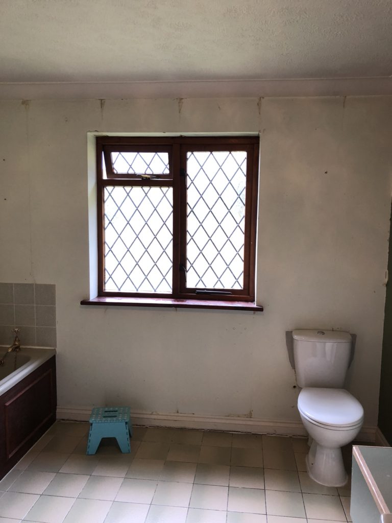 bathroom window and toilet before bathroom refresh