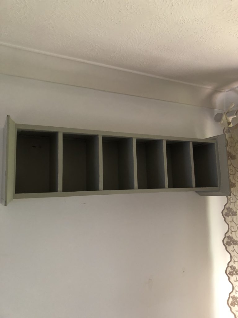 recycled CD storage unit fixed horizontally to wall