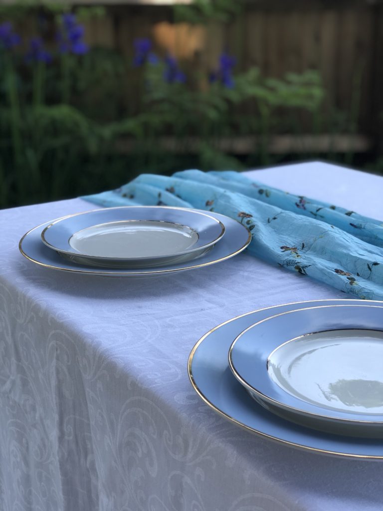 Blue plates on white tablecloth create simple table decoration