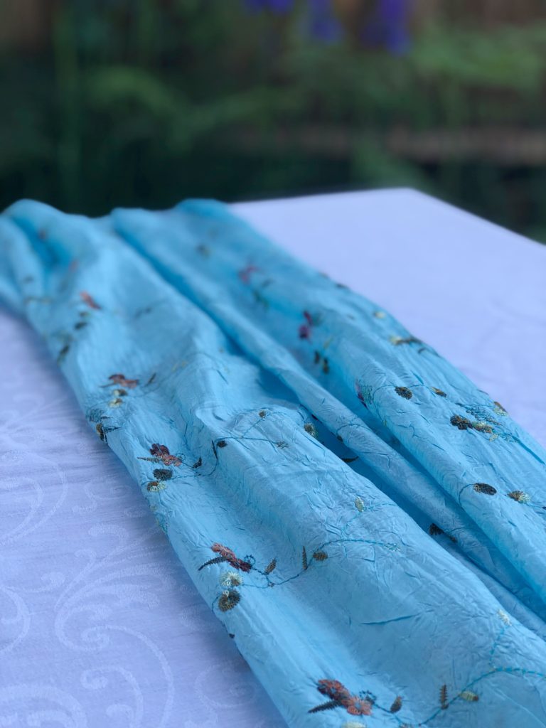 pale blue scarf on white tablecloth