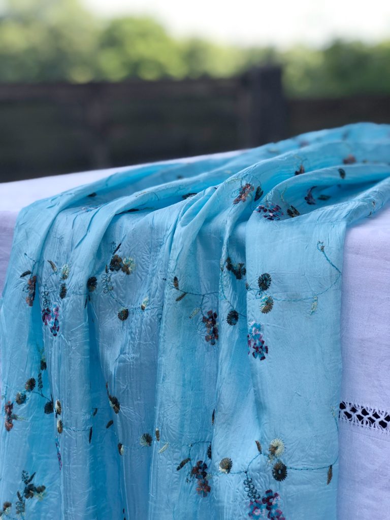 pale blue scarf on white tablecloth