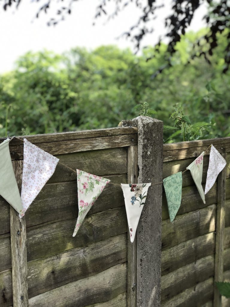 home made bunting on vintage garden fence