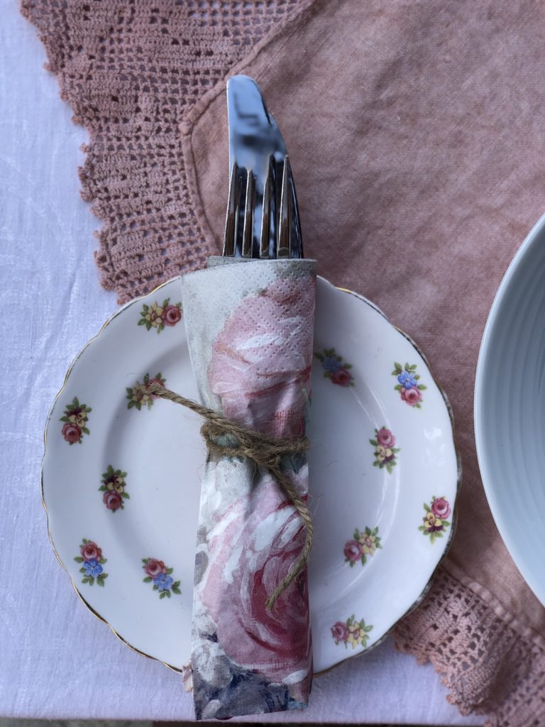 vintage rose tea plate, napkin and cutlery on pink cloth