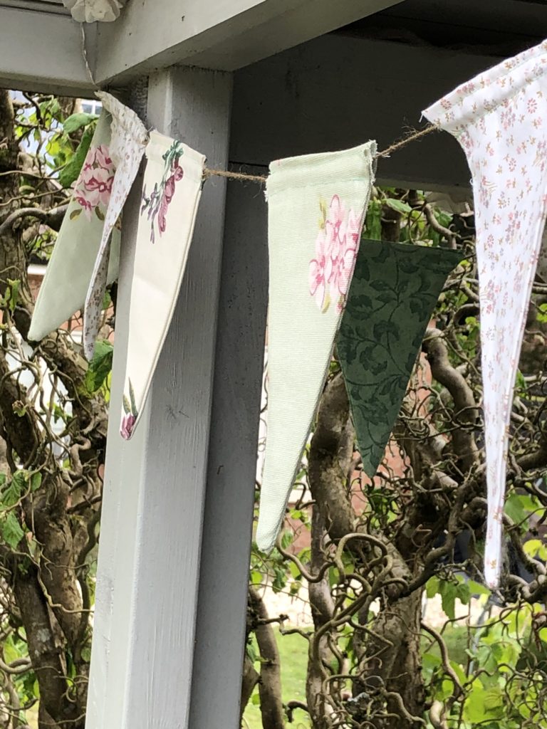 homemade fabric bunting forms part of diy summer party decorations