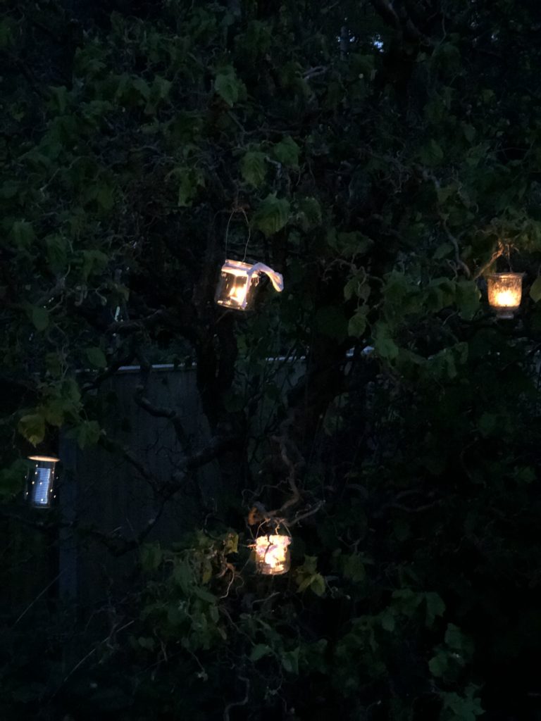  jam jar night lights in a tree  form part of diy summer party decorations