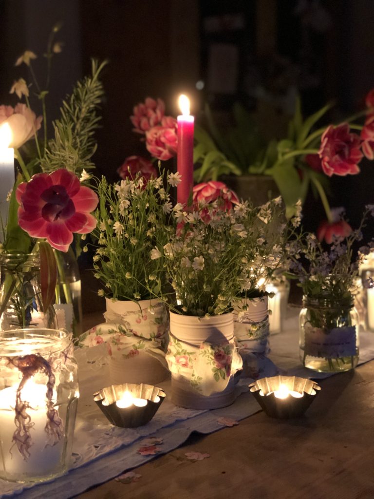 recycled pink tin cans with flowers glass jars with candles and tealights and flowers