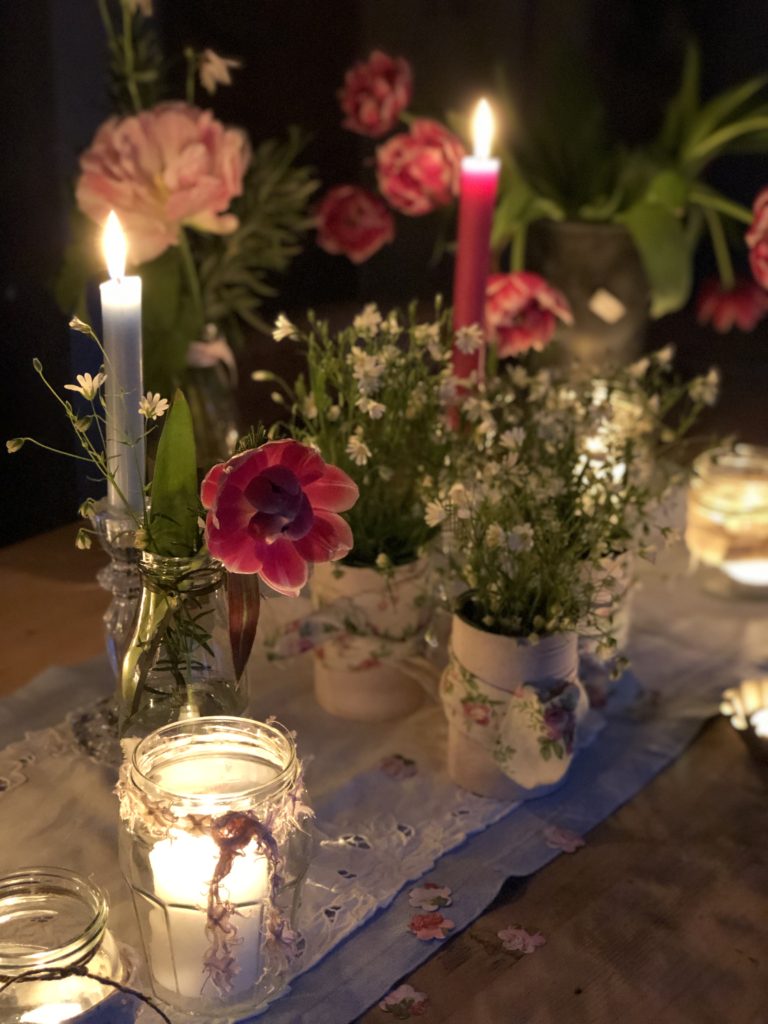 recycled pink tin cans with flowers glass jars with candles and tealights and flowers