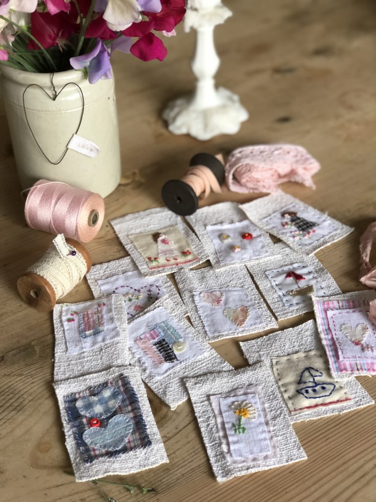 scraps of vintage fabrics and embroidery to make up fabric mini bunting