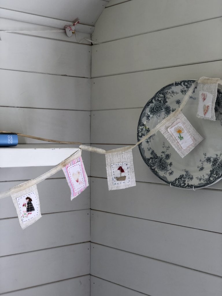 mini fabric bunting dresses painted shelf with wall plate on painted tongue and groove wall 