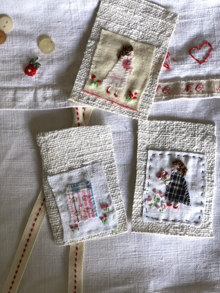 embroidered pieces of vintage material ladies and houses