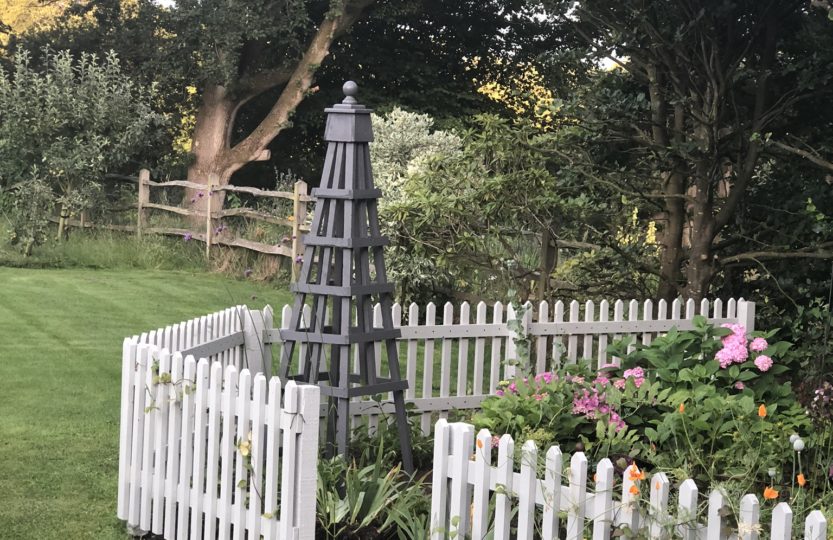 wooden obelisk in cottage garden