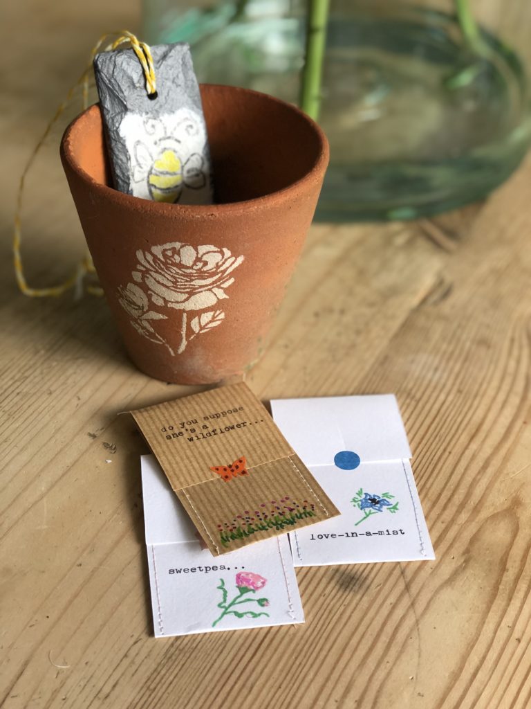 stenciled terracotta pot with seed packet wrap and diy slate garden marker 