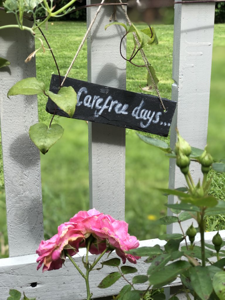 slate plant marker on picket fence