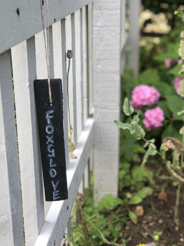 slate plant marker on picket fence