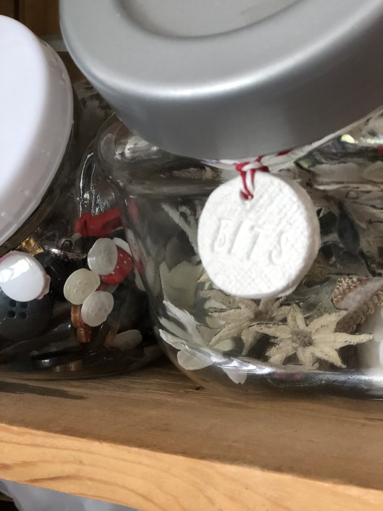 clay tag on glass storage jar