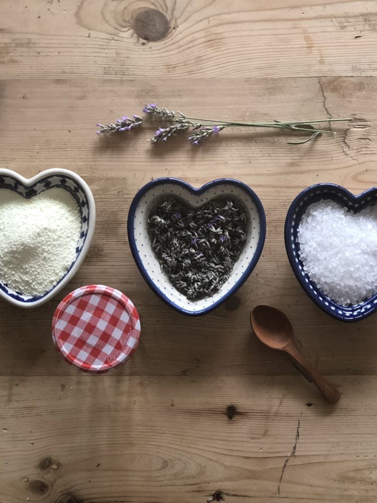 3 blue pottery heart dishes with lavender, salt and milk powder and glass jar and wooden spoon