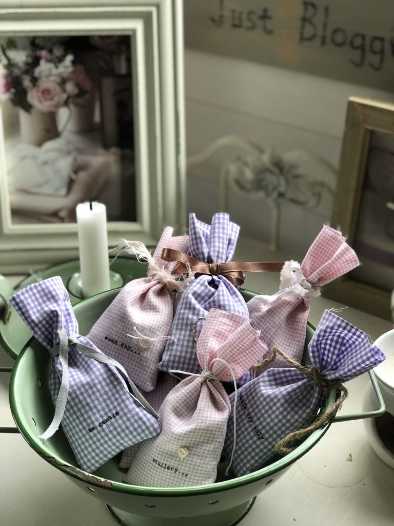 homemade lavender dryer bags in green collander with candle