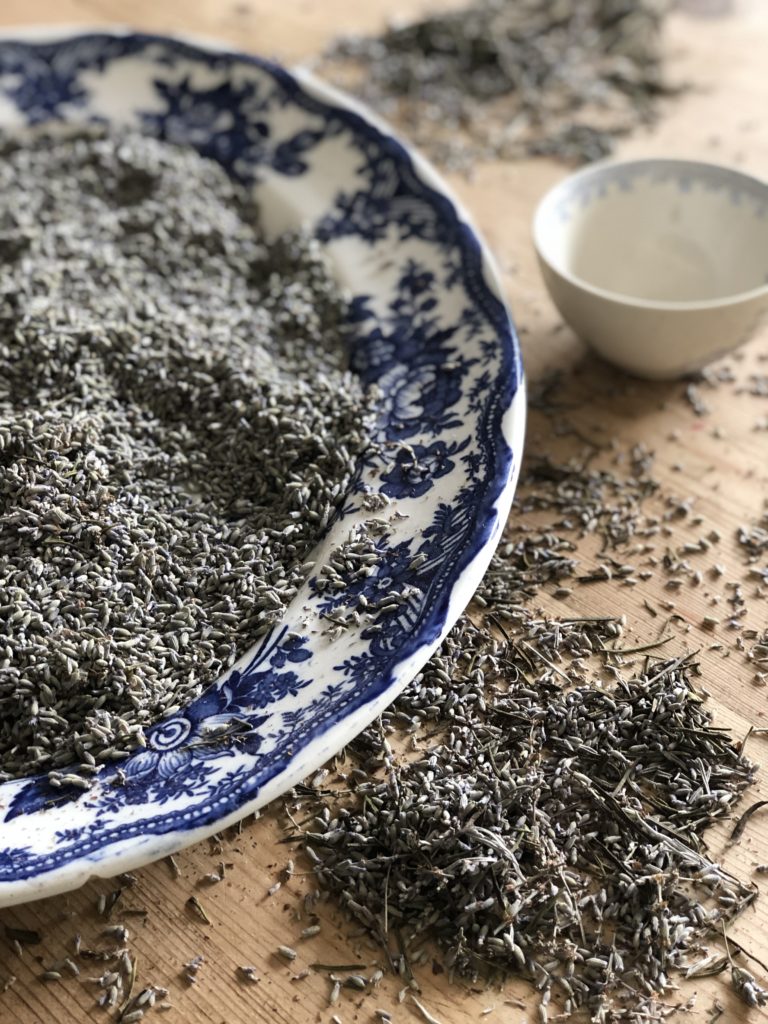 dried lavender buds on blue plate on table top