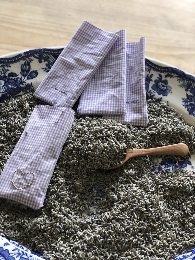 lavender buds filling up purple gingham lavender bags