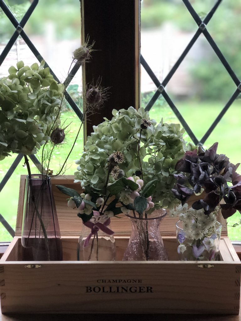 hydrangeas and seed heads used in autumn window decoration