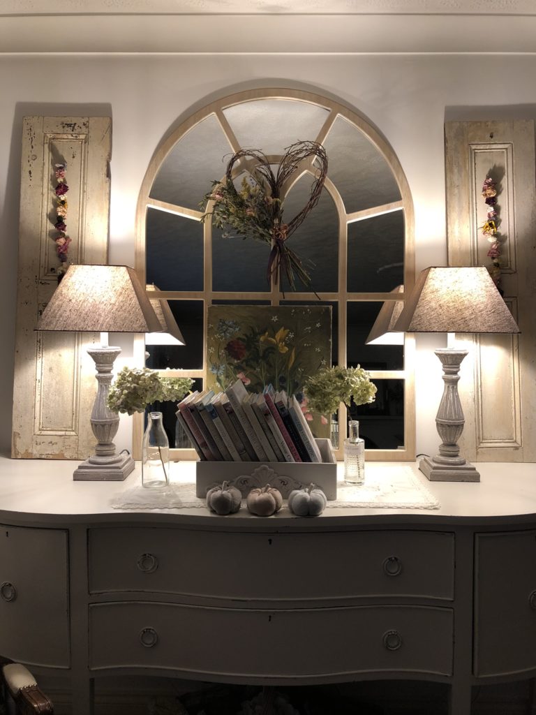 sideboard in sitting room with seasonal autumn home decor