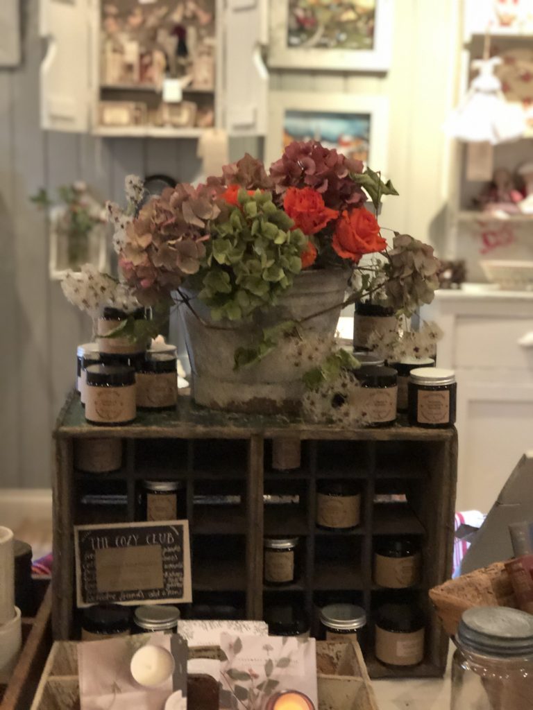 wooden candle cubby and hydrangea display