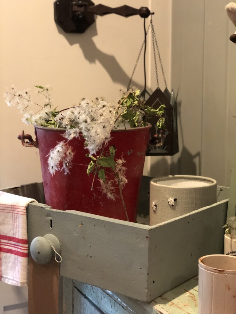 red fire bucket in painted drawer with old mans beard decoration