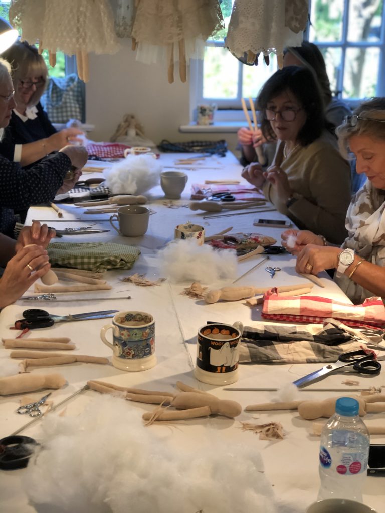 ladies gather at craft table to create heirloom fairies