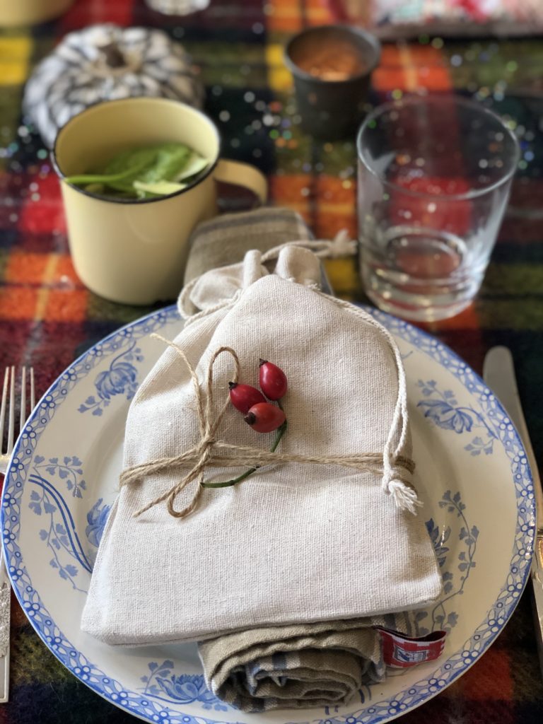 calico gift bag with rosehip on blue and white plate