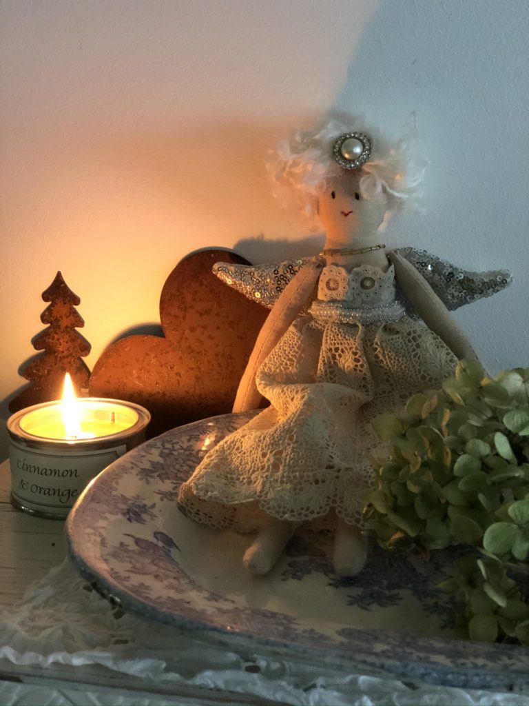 pretty heirloom fairy on blue platter with rusty decor and candle