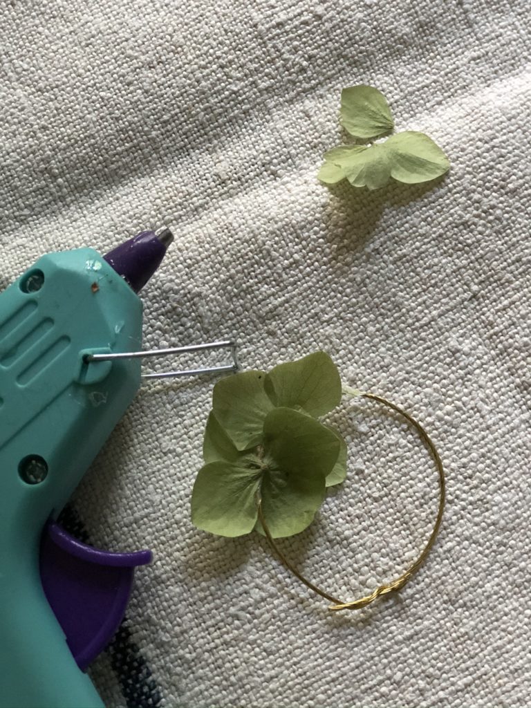 glue gun, hydrangea petals and gold ring create simple autumn decorating ideas