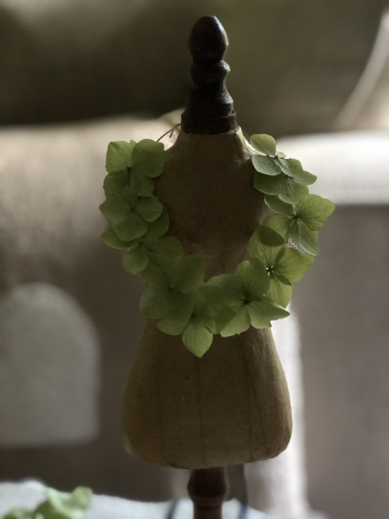 green hydrangea petal decoration on mannequin