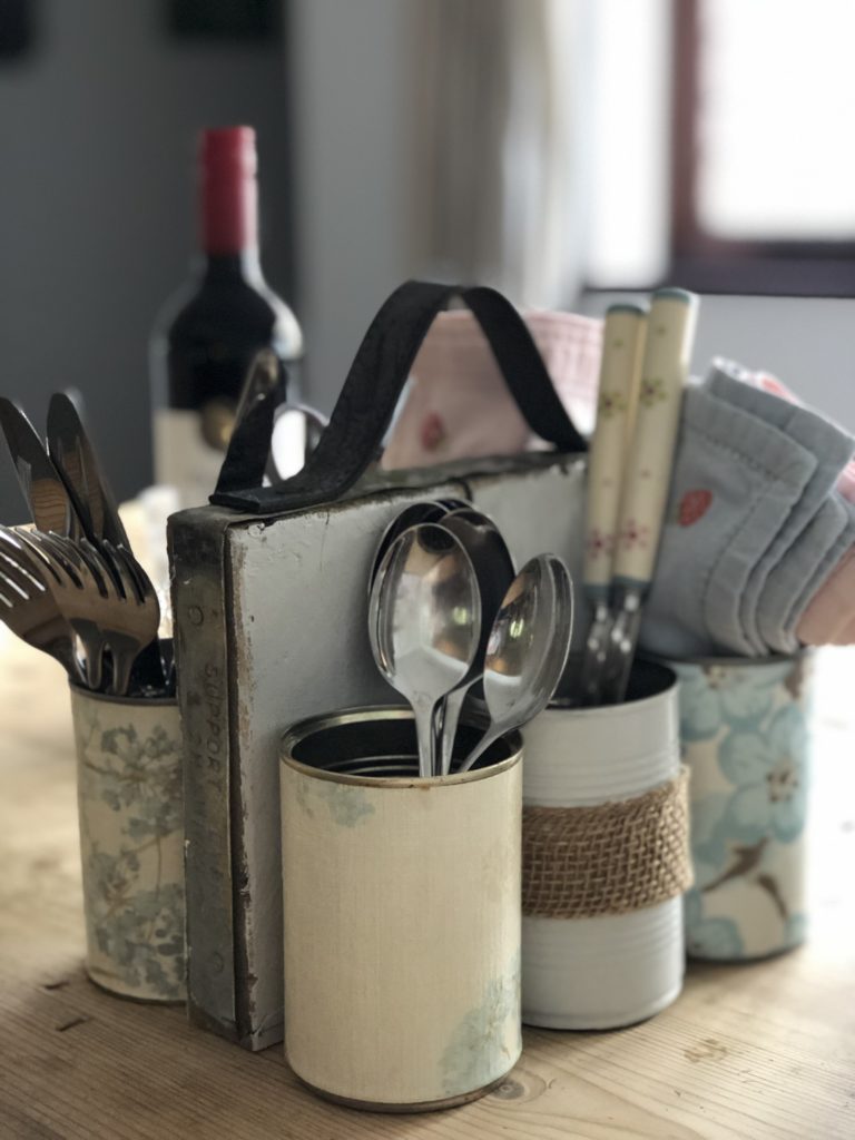 homemade tin can organiser holds cutlery and napkins