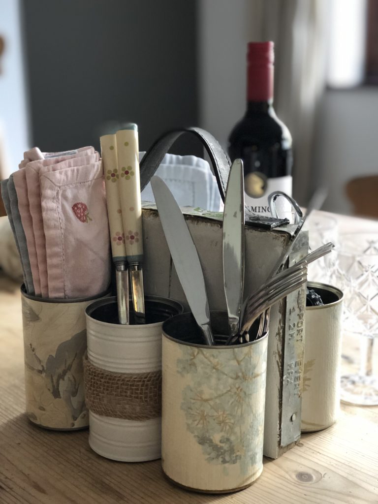 homemade tin can organiser holds cutlery and napkins